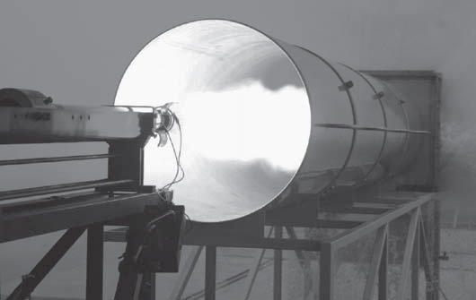 A photograph of a static firing in DSTG's rocket motor test facility.
